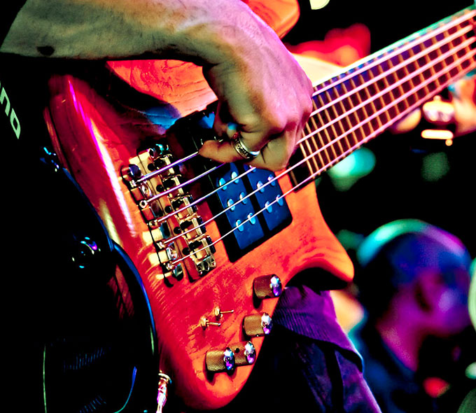 Closeup of a Man Playing a Bass Guitar